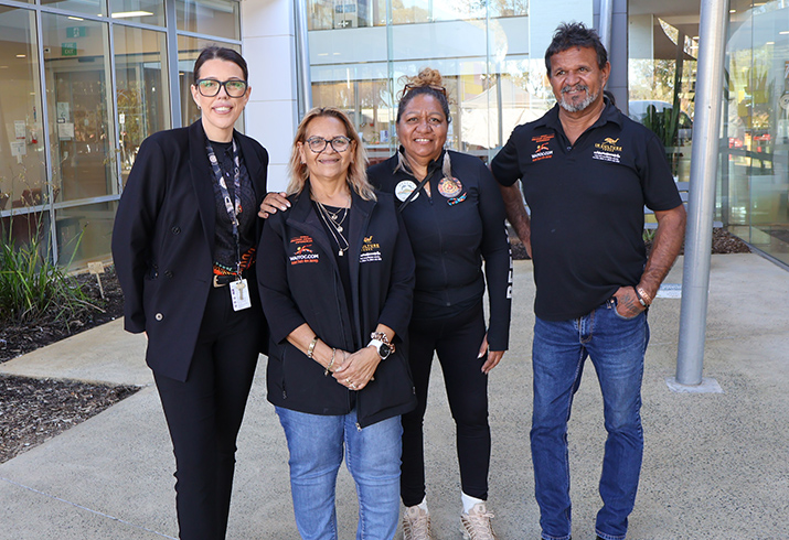 A group of four Aboriginal people standing in the courtyard of Rockingham General Hospital 